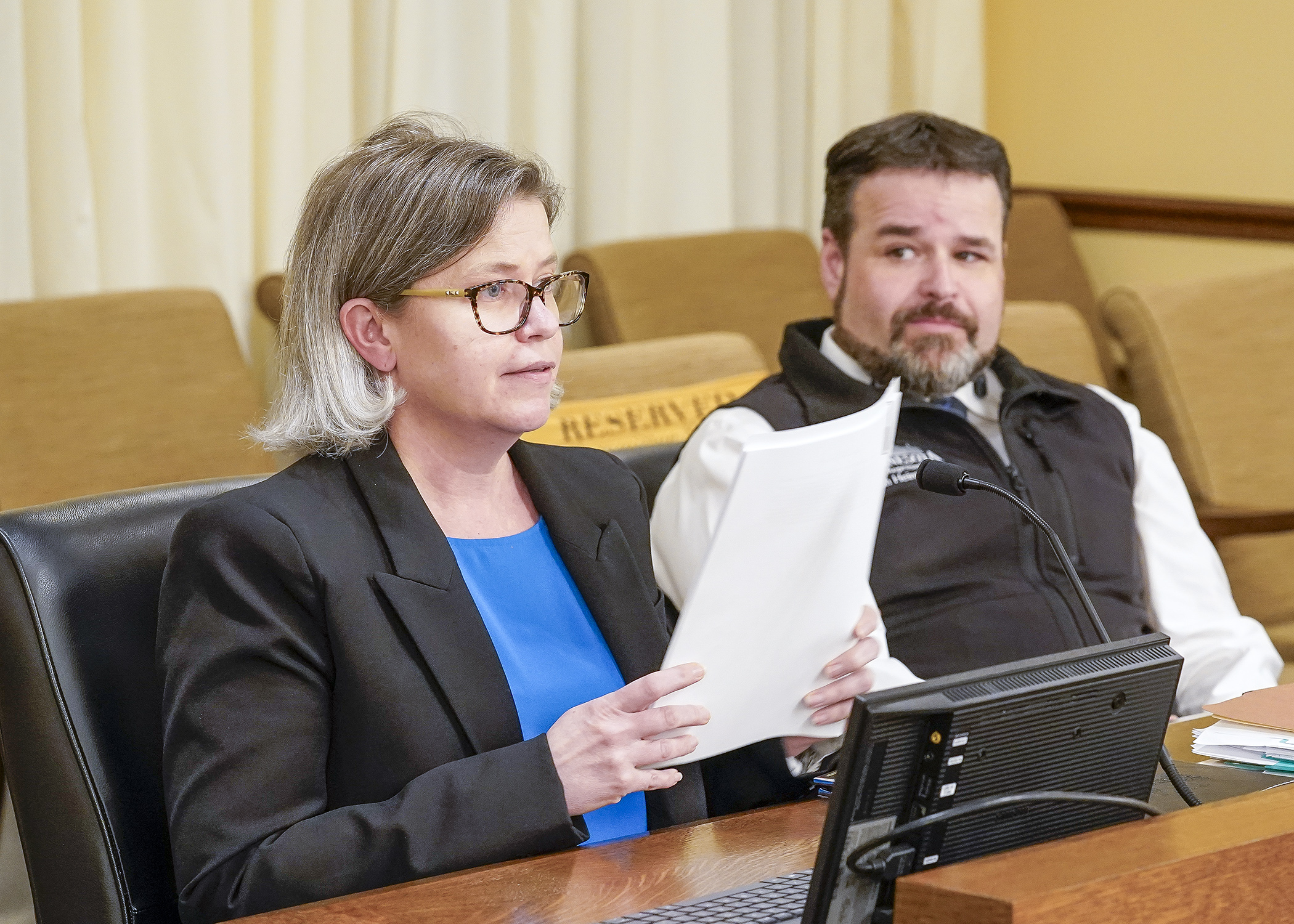 Legislative Coordinator Barbara Keller walks through the DNR policy bill with Rep. Josh Heintzeman at the April 14 meeting of the House Environment and Natural Resources Finance and Policy Committee. (Photo by Andrew VonBank)